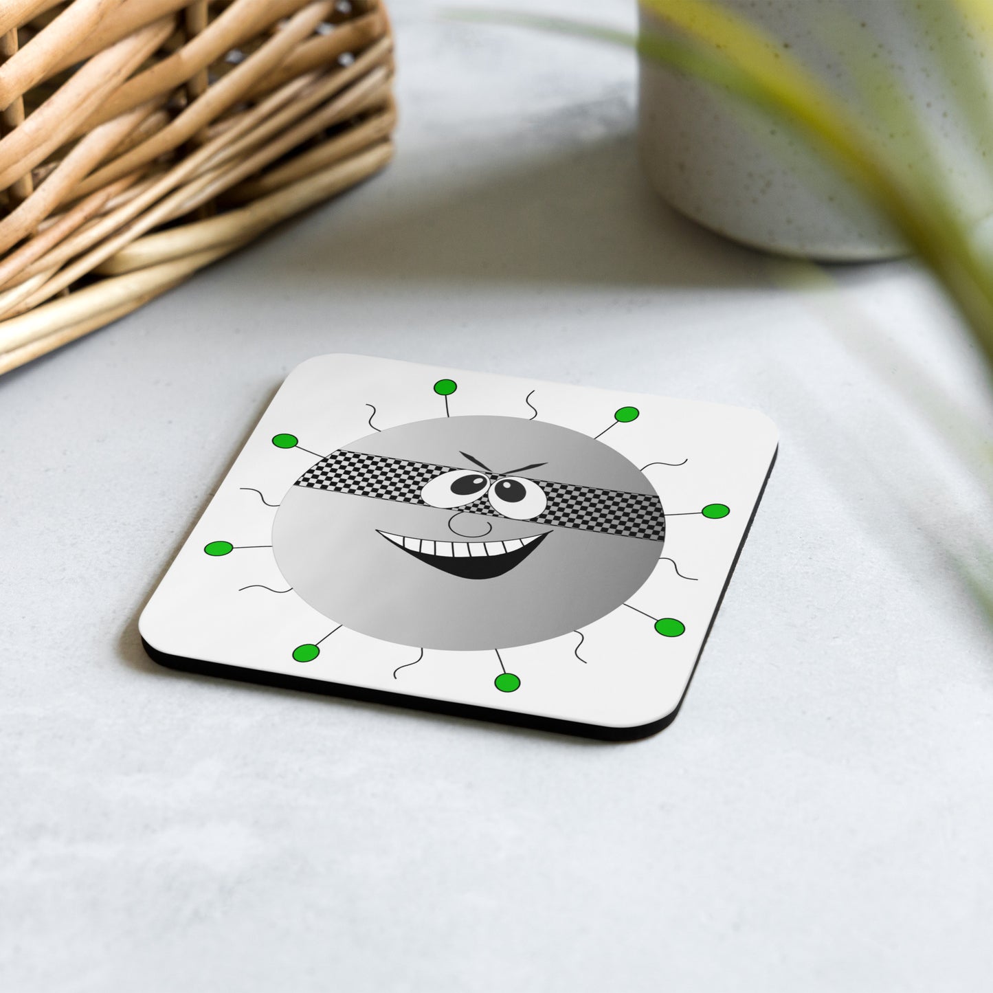 Cartoon image of a virus on a cork-backed coaster