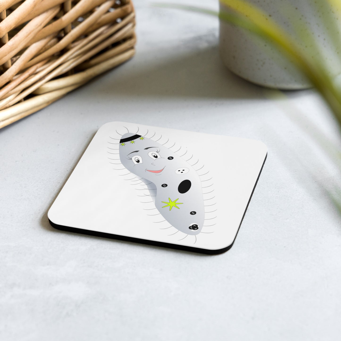 Cartoon image of a paramecium on a cork-backed coaster