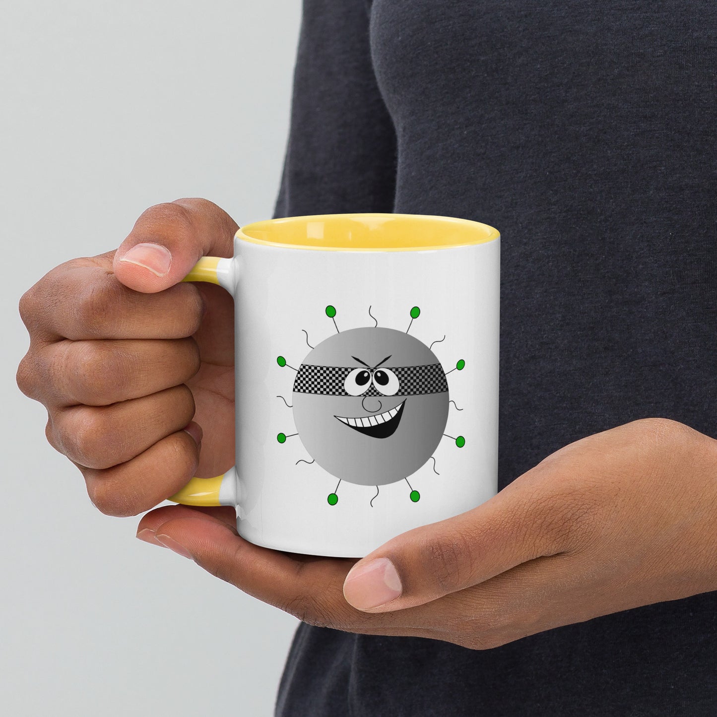 Mug featuring a whimsical cartoon image of a virus and a burst of color inside.