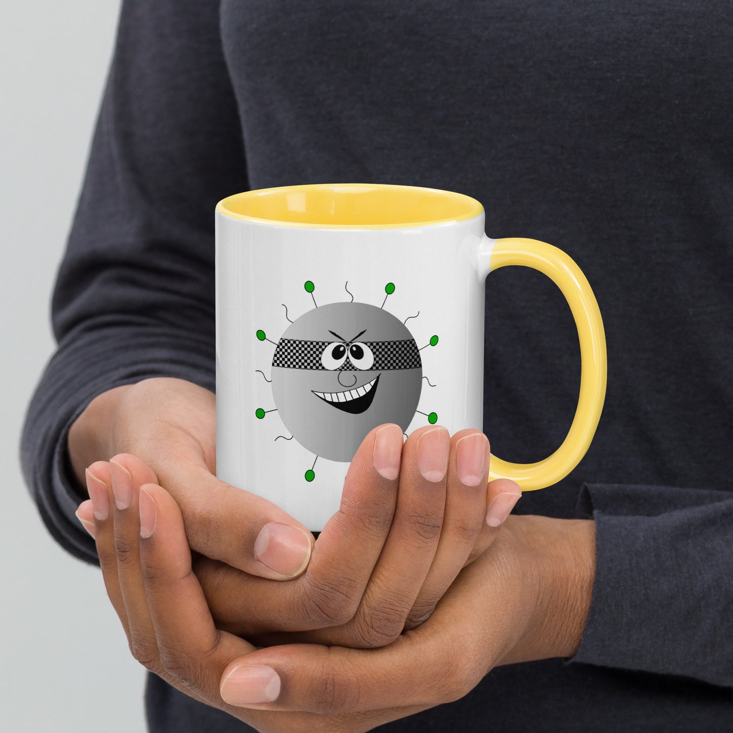 Mug featuring a whimsical cartoon image of a virus and a burst of color inside.